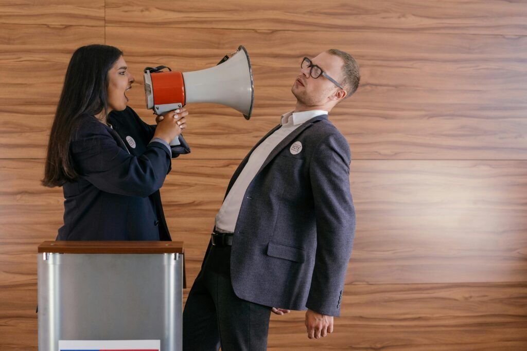 Two people in a heated debate, one shouting into a megaphone